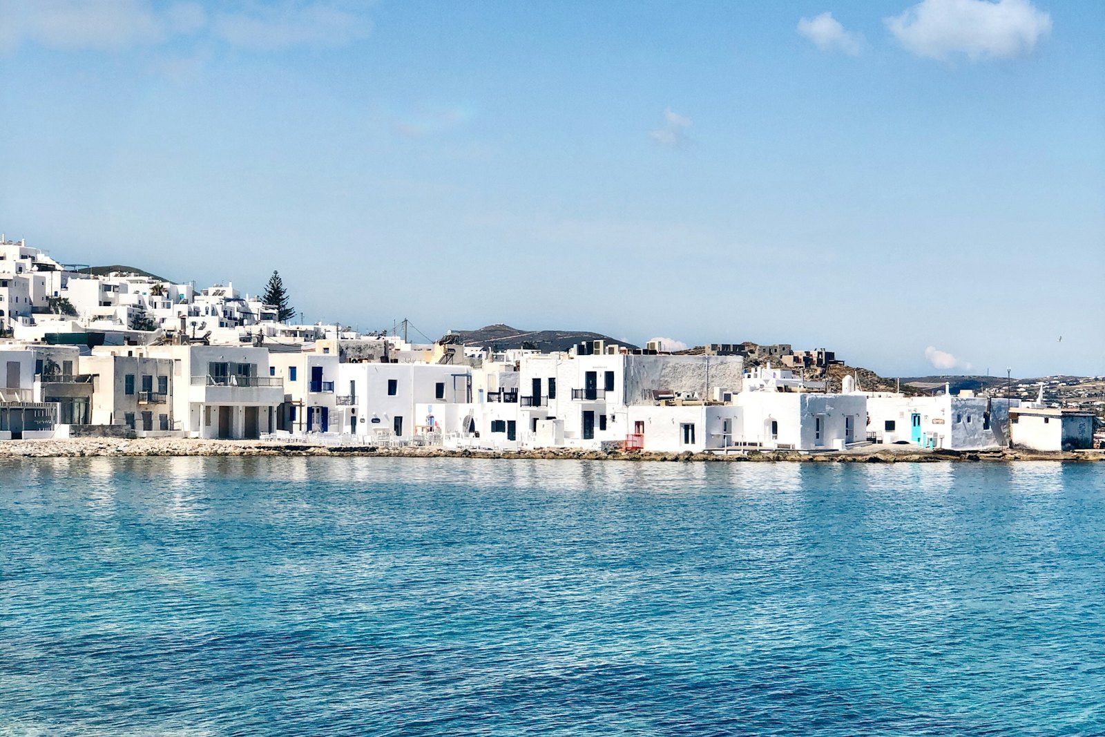 White houses and still boats in a small harbour
