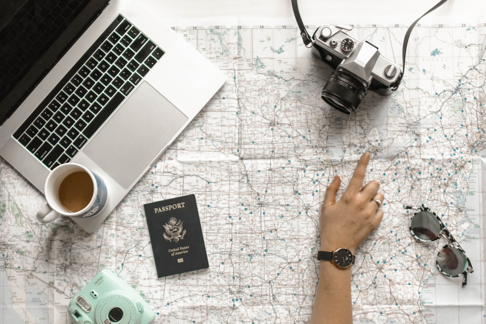 A passport, a map and a camera laid out before leaving