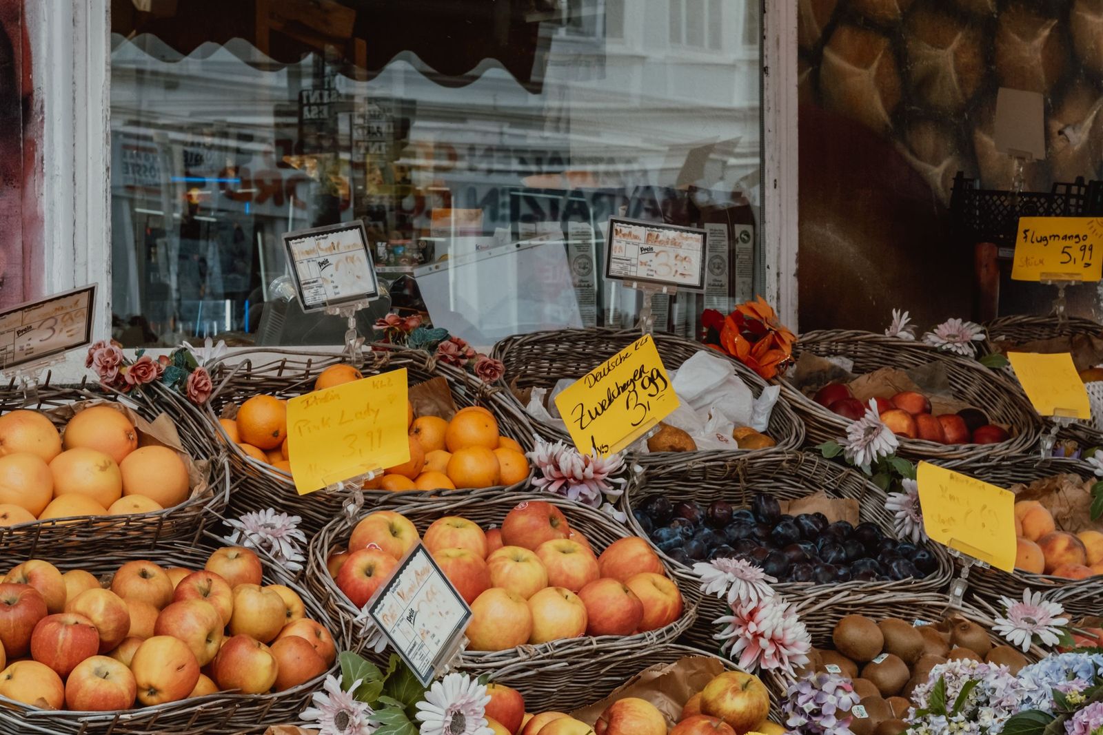 Fruit and flowers laid out at a neighbourhood market stall